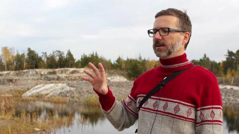 Erich Berger speaks in rocky landscape